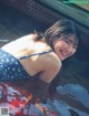 A woman in a blue and white bathing suit in a pool.