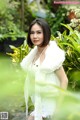 A woman in a white dress posing for a picture.