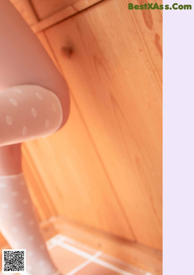A close up of a doll's legs in white tights.