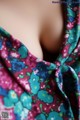 A close up of a woman's neck with a floral print dress.